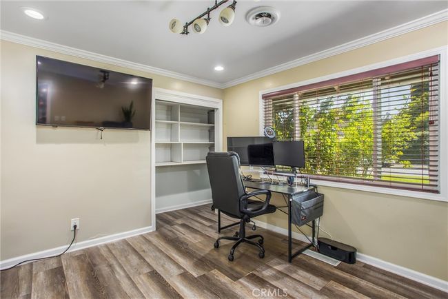 Office with a window view of the front of the home and street view. | Image 18