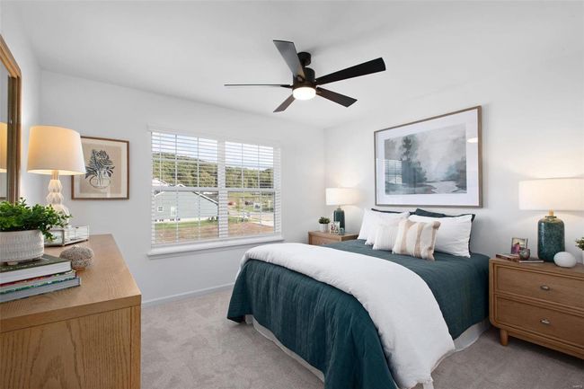 Bedroom featuring ceiling fan and light colored carpet | Image 20