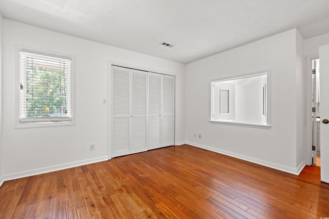 Unfurnished bedroom with wood-type flooring and a closet | Image 24