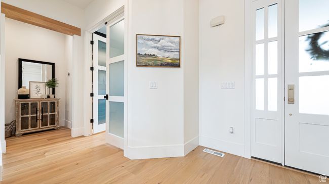 Entryway with light wood-type flooring, baseboards, visible vents, and a healthy amount of sunlight | Image 6