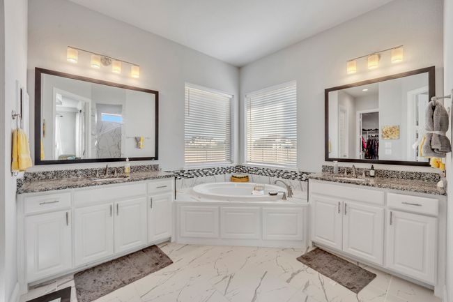 Bathroom featuring a bathing tub and vanity | Image 17