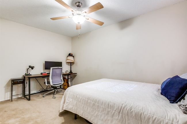 Carpeted bedroom featuring a ceiling fan | Image 7