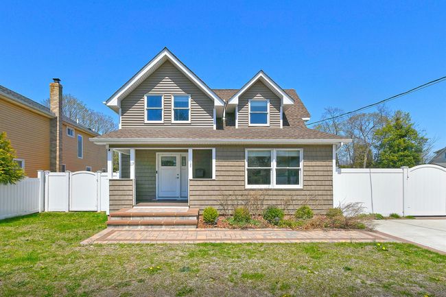 View of front of home with a gate, roof with shingles, a front yard, and fence | Image 5