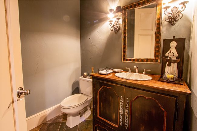 Bathroom featuring baseboards, toilet, tile patterned flooring, and vanity | Image 16