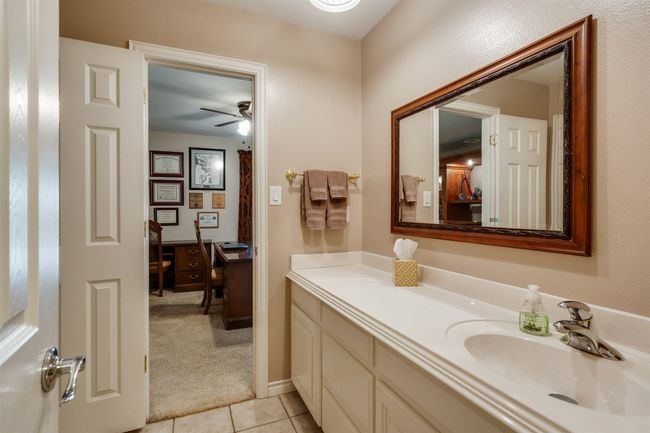 Bathroom with tile patterned flooring, a ceiling fan, and vanity | Image 21