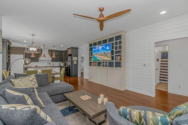 Living room featuring ceiling fan, dark wood-style floors, a chandelier, recessed lighting, and a textured ceiling | Image 6