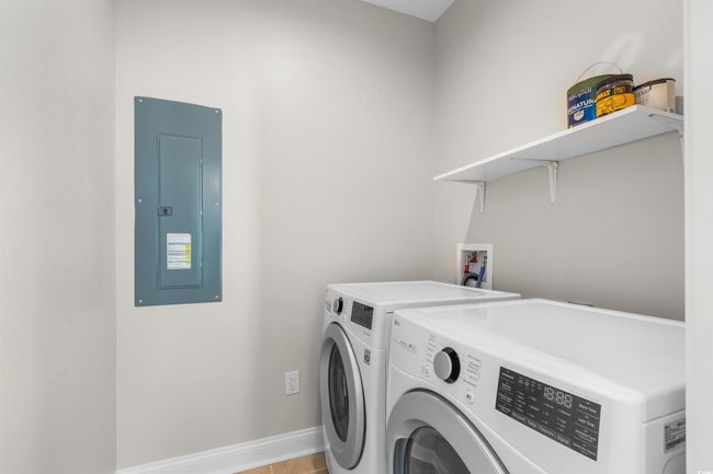 Laundry area featuring electric panel, independent washer and dryer, and baseboards | Image 20