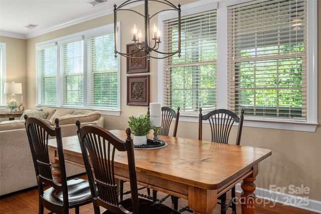 Dining area overlooks screened porch and beautiful greenery in rear yard | Image 15