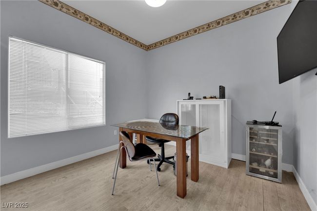 Home office with light wood-style flooring and baseboards | Image 19