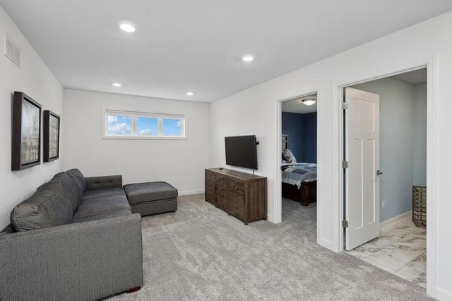 (Photo of decorated model, actual home's finishes will vary) Located on the upper level, this perfectly sized living space has enough room for a desk, television and seating for all. | Image 11