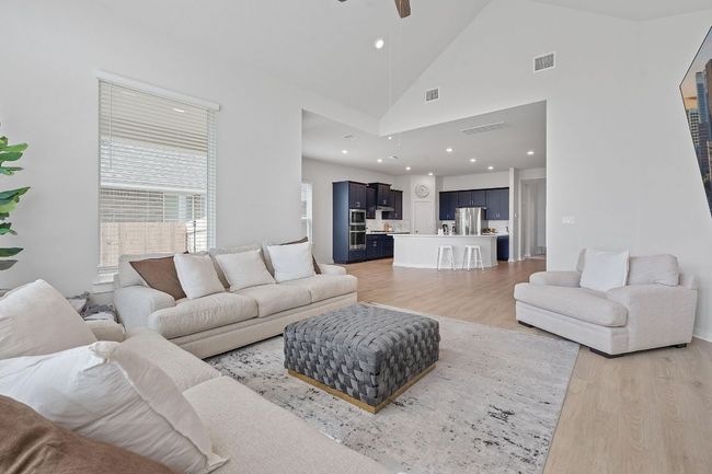 Living room with recessed lighting, light wood-type flooring, visible vents, and ceiling fan | Image 6