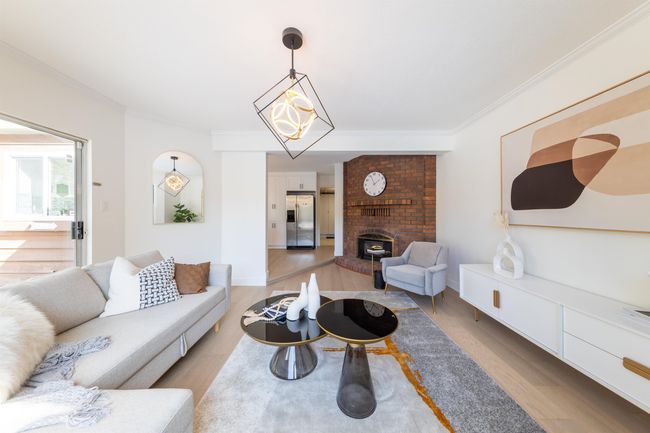 Living area with ornamental molding and light wood-style floors | Image 18