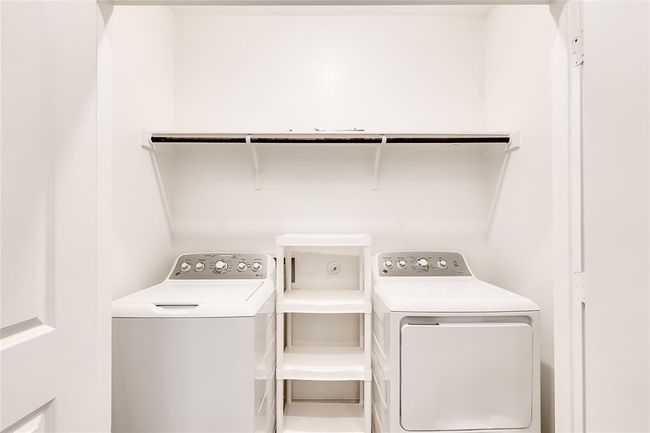 Washroom with washing machine and clothes dryer | Image 24