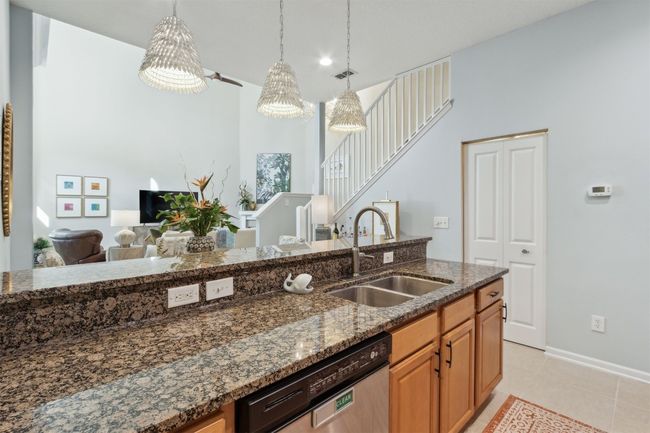 Clean cabinetry and stone countertops. | Image 12