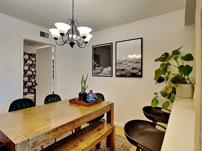 Dining room featuring a chandelier and wood finished floors | Image 7