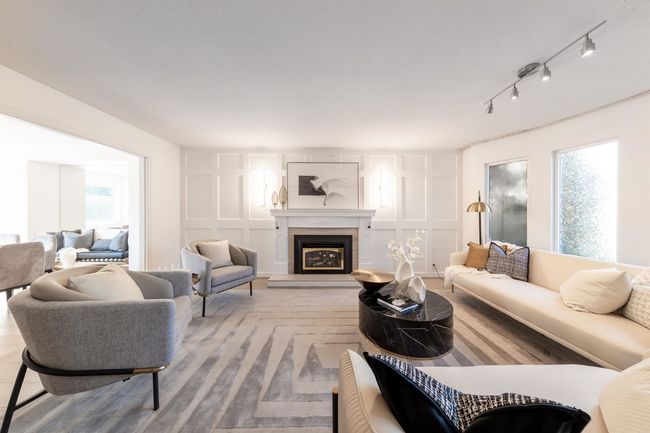 Living area featuring rail lighting, a decorative wall, and a glass covered fireplace | Image 23