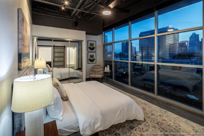 Bedroom featuring a skyline view, wood finished floors, and a closet | Image 10