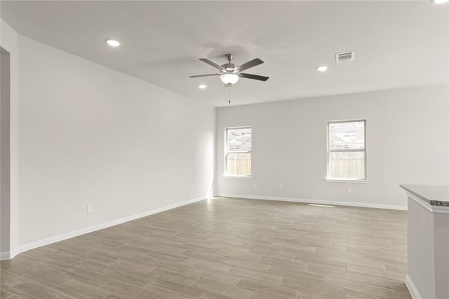 Unfurnished room featuring ceiling fan, light wood-style floors, and recessed lighting | Image 8