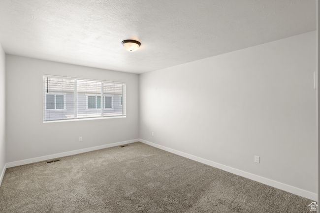 Carpeted spare room with baseboards and a textured ceiling | Image 19