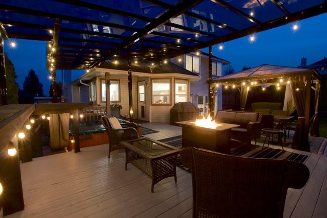 Deck at twilight with an outdoor living space with a fire pit and a pergola | Image 28