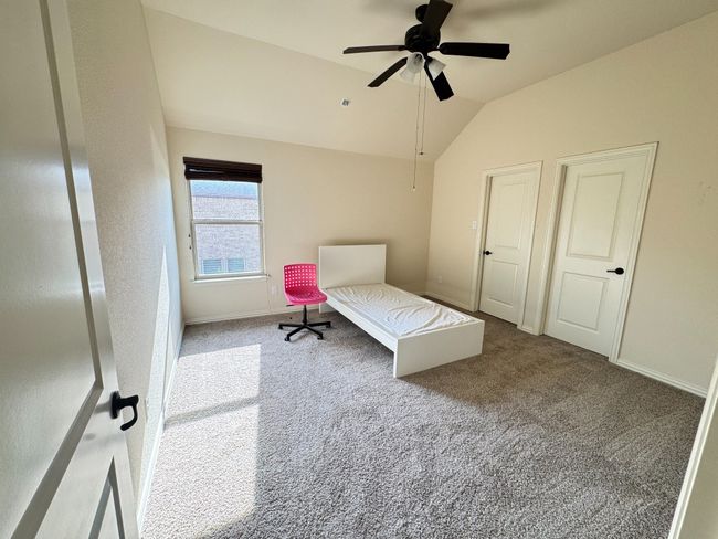 Bedroom featuring lofted ceiling, carpet floors, and a ceiling fan | Image 21
