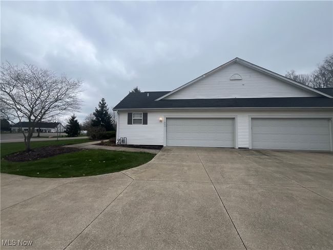 The 2-car garage for this unit is on the left. The expansive driveway offers ample space for guest parking. | Image 33