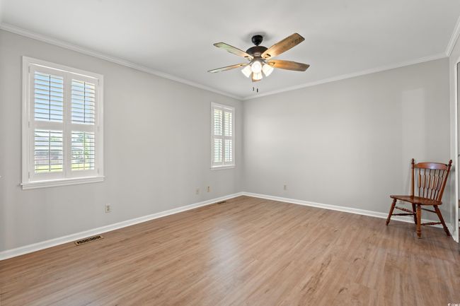 Spare room featuring light wood-style flooring, ornamental molding, and ceiling fan | Image 31