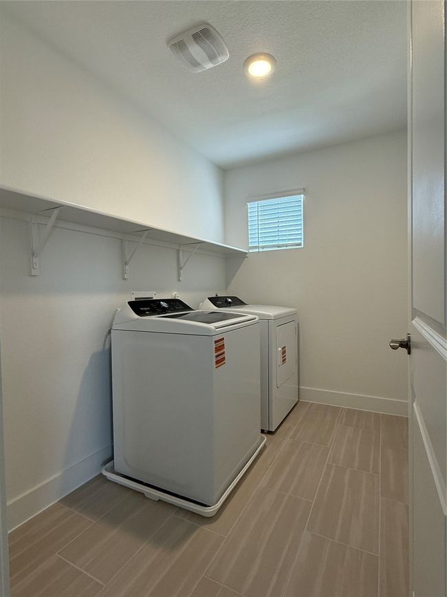 Washroom featuring washing machine and clothes dryer and baseboards | Image 29