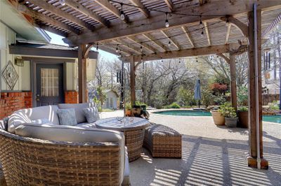 View of patio featuring a pergola and outdoor lounge area | Image 1