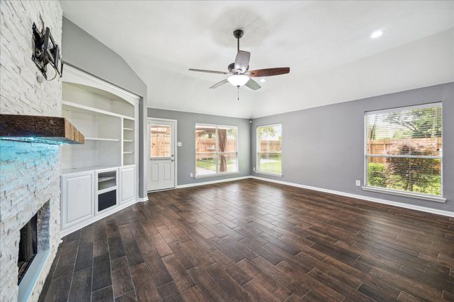 Ample living area with updated custom fireplace. | Image 9
