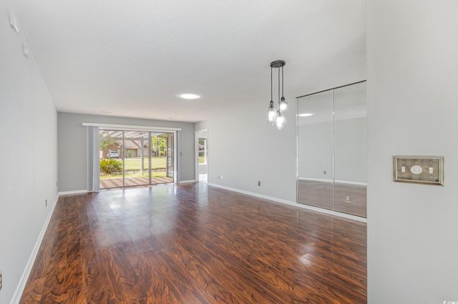 Spare room with baseboards and wood finished floors | Image 6
