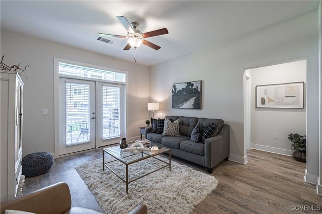 Living room featuring visible vents, baseboards, ceiling fan, dark wood finished floors, and french doors | Image 29