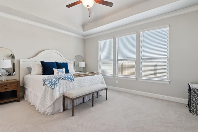 Bedroom with light colored carpet, ceiling fan, and baseboards | Image 12