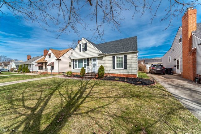 View of front facade featuring a shingled roof, a residential view, a front yard, and concrete driveway | Image 5