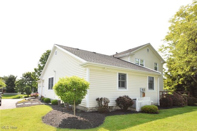 View of property exterior featuring a yard and roof with shingles | Image 31
