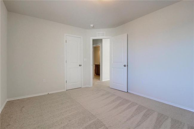 Spare room featuring light carpet and baseboards | Image 32