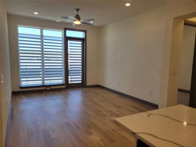 Empty room featuring ceiling fan, baseboards, wood finished floors, and recessed lighting | Image 9