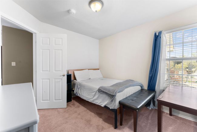 Bedroom featuring lofted ceiling and light carpet | Image 22