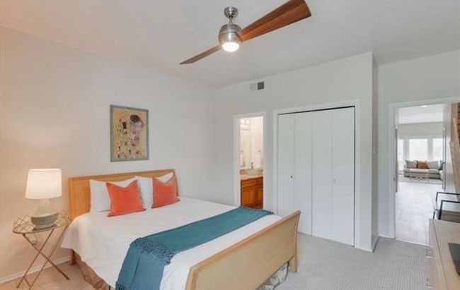 Bedroom with light carpet, a closet, a ceiling fan, and ensuite bathroom | Image 14