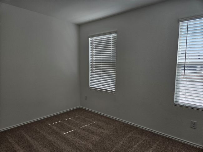 Spare room featuring dark carpet | Image 13