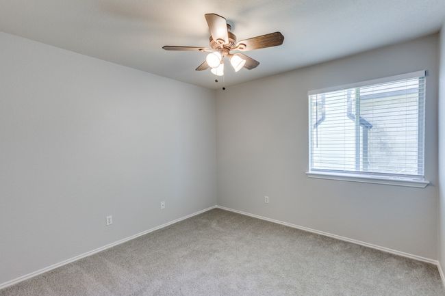 Bed #2 Carpeted spare room with a ceiling fan and baseboards | Image 23