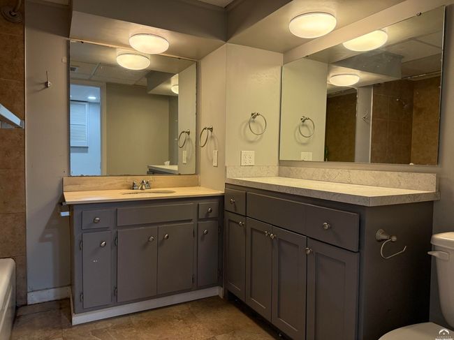 Adjoined to the largest bedroom in the house, the full bath has tub, shower, toilet, double counter | Image 51