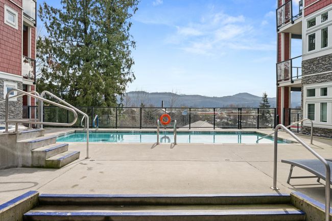 Community pool featuring a mountain view and a patio | Image 36