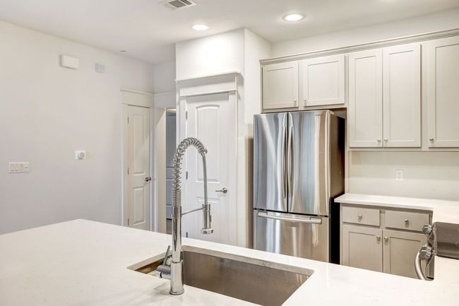 Kitchen featuring appliances with stainless steel finishes, a sink, light countertops, and recessed lighting | Image 9