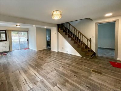 Unfurnished living room featuring hardwood / wood-style floors | Image 3