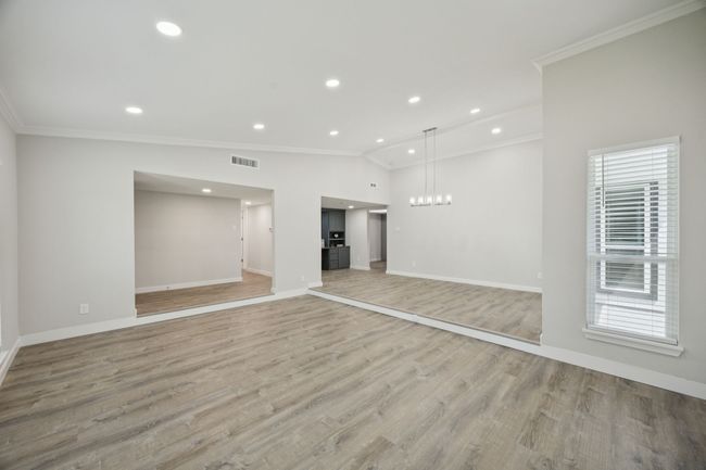 Here is another view of the Living and Dining area looking towards the Custom Built-ins, Hall to Bedrooms, and the Breakfast area - Love the open concept living areas! | Image 13