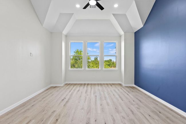 The primary bedroom has a beautiful ceiling, new ceiling fan, new flooring & new paint | Image 16