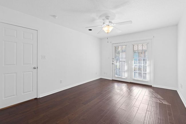 Unfurnished room featuring baseboards, dark wood finished floors, and a ceiling fan | Image 20