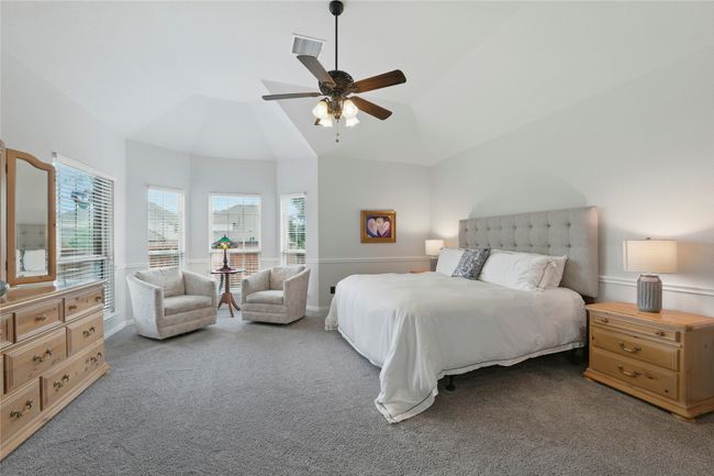 Bedroom featuring carpet, multiple windows, lofted ceiling, and a ceiling fan | Image 20