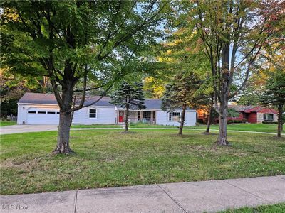 View of front of home with a garage and a front lawn | Image 1